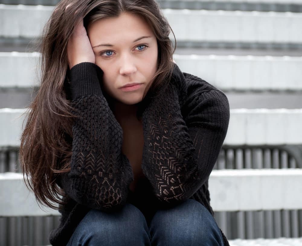 Photo of teen girl with sad expression on their face